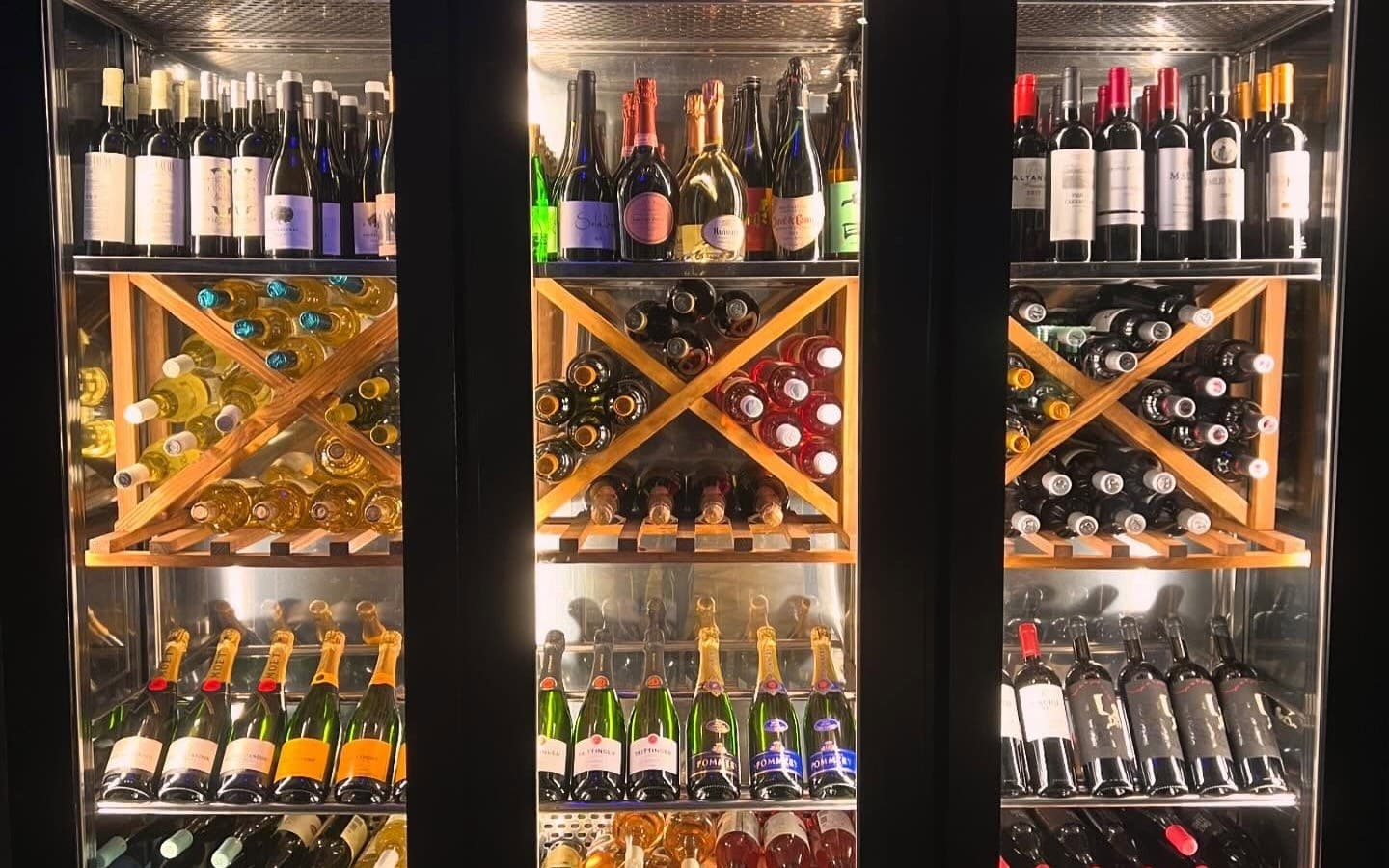 Nevera de vinos iluminada, llena de botellas
